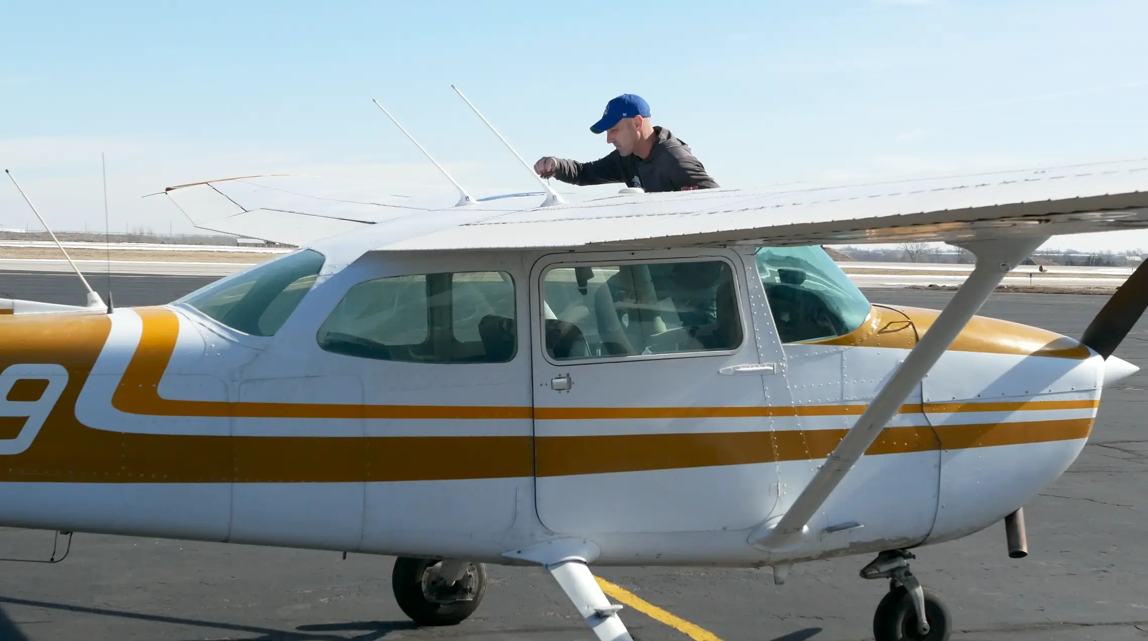 Pilot Instructional Center - Pilot checking wing of plane during flight school pilot training