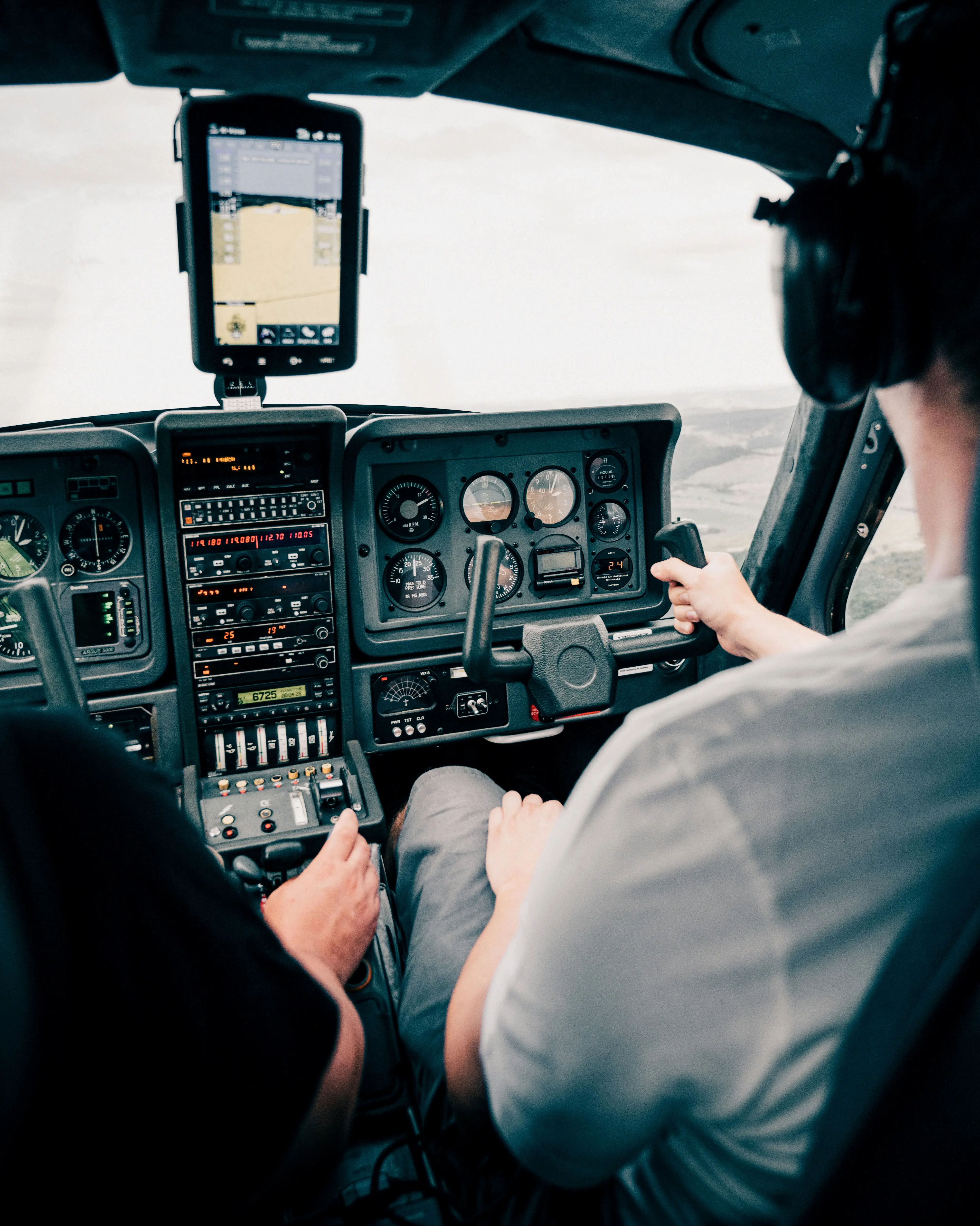 Aircrew member using control panel in airplane cockpit