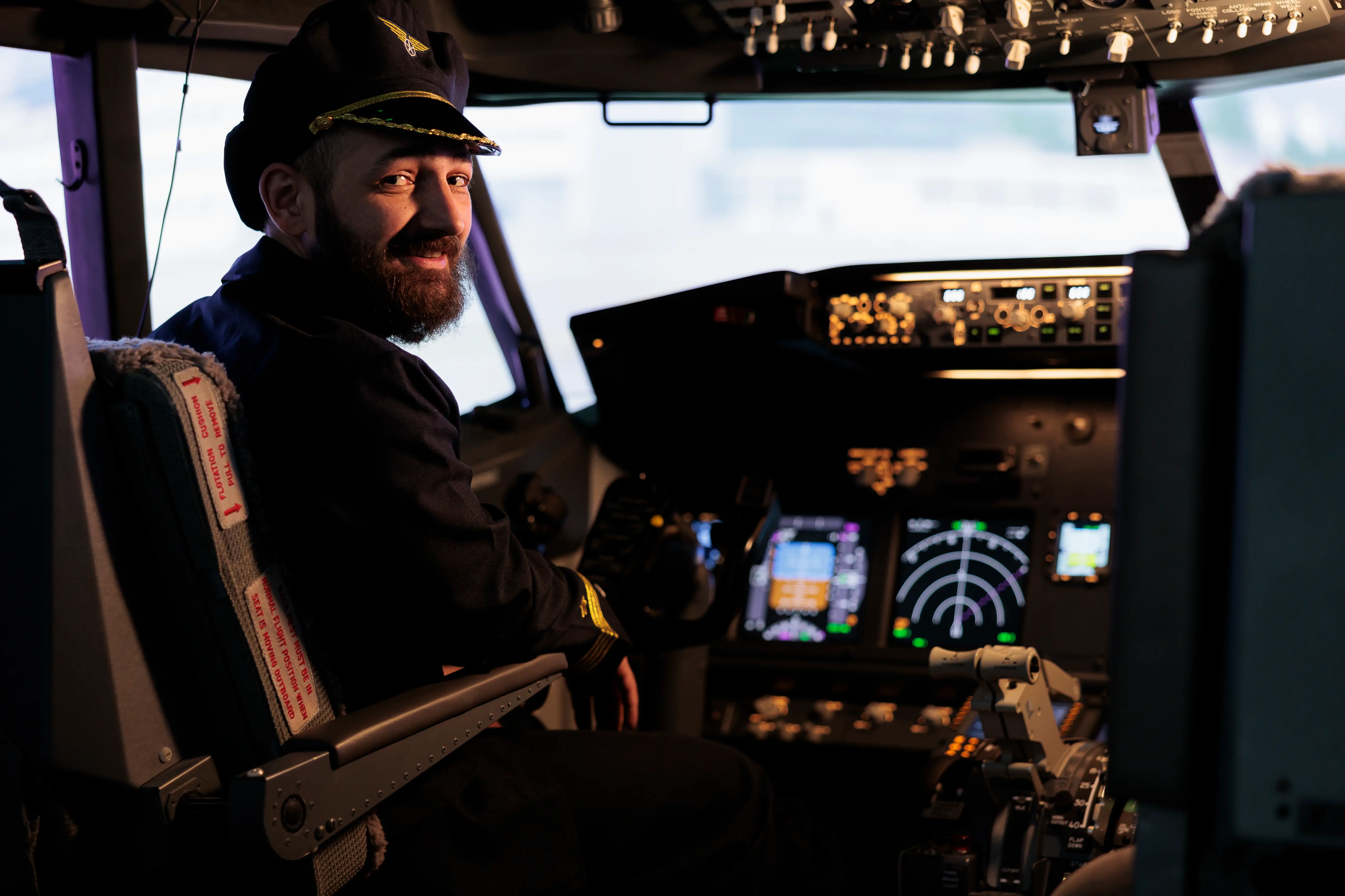 Aircrew member using control panel in airplane cockpit