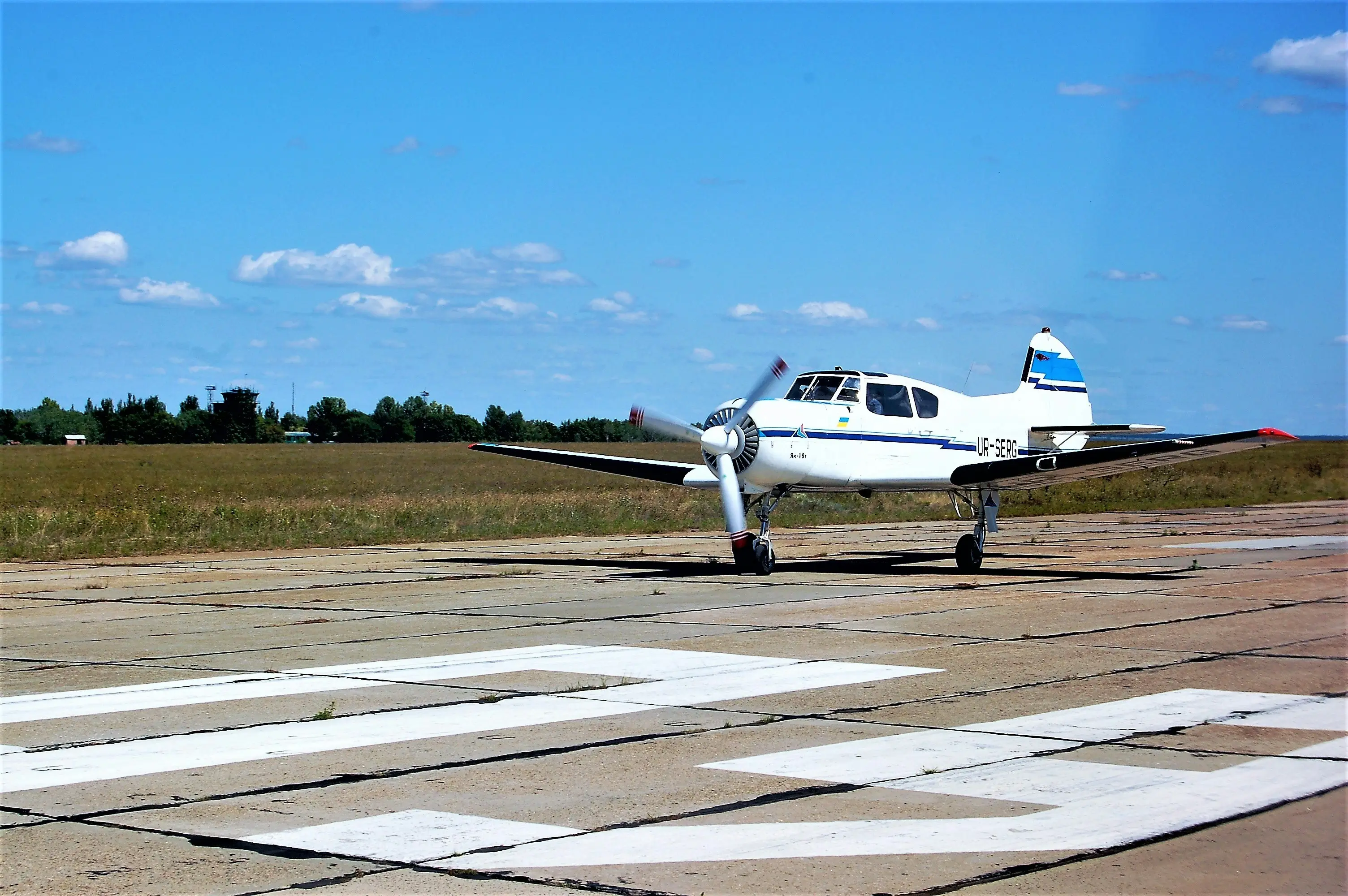 Airplane on ground near road by Oleksandr Brovko