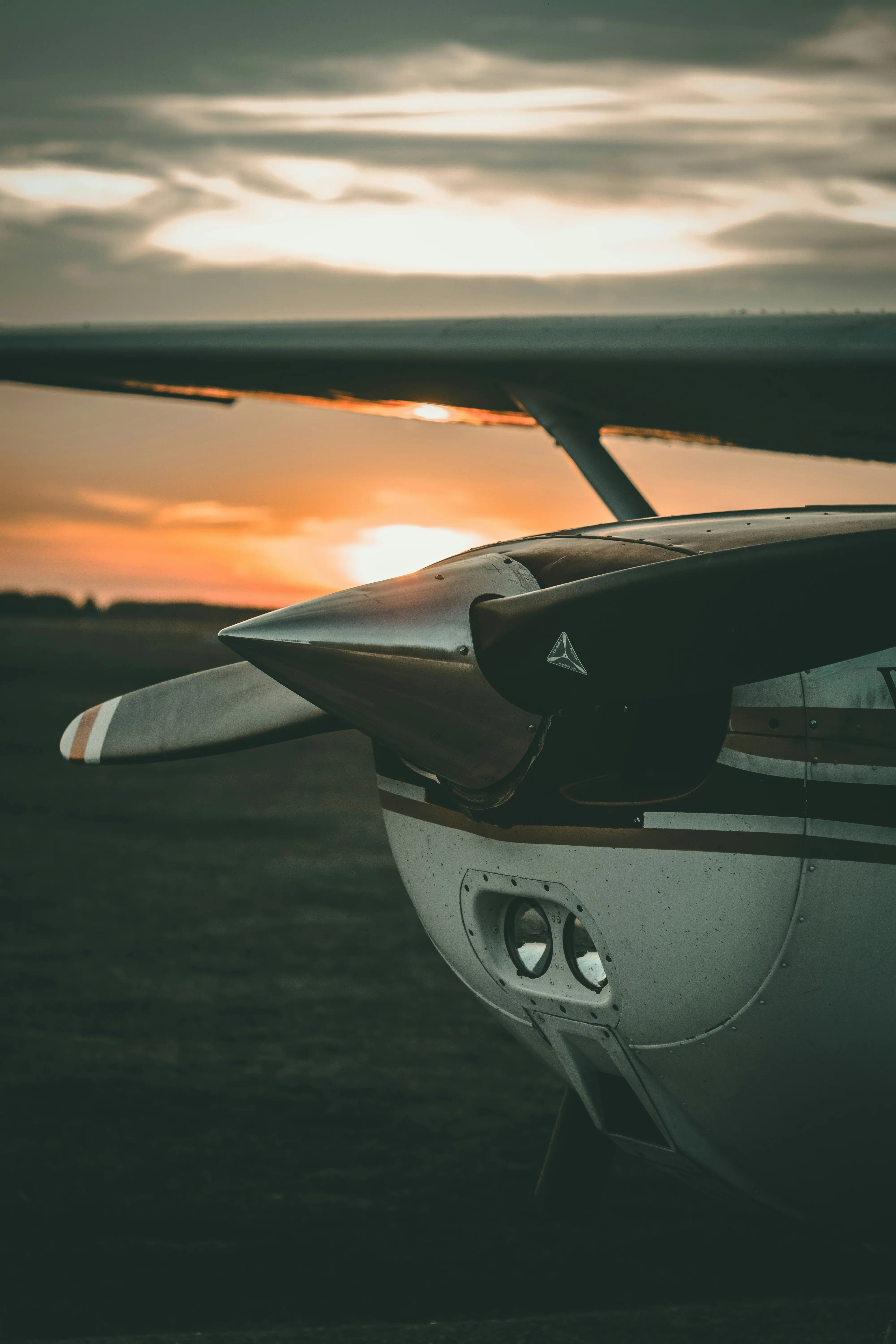 Airplane on ground at sunset by Roland Denes