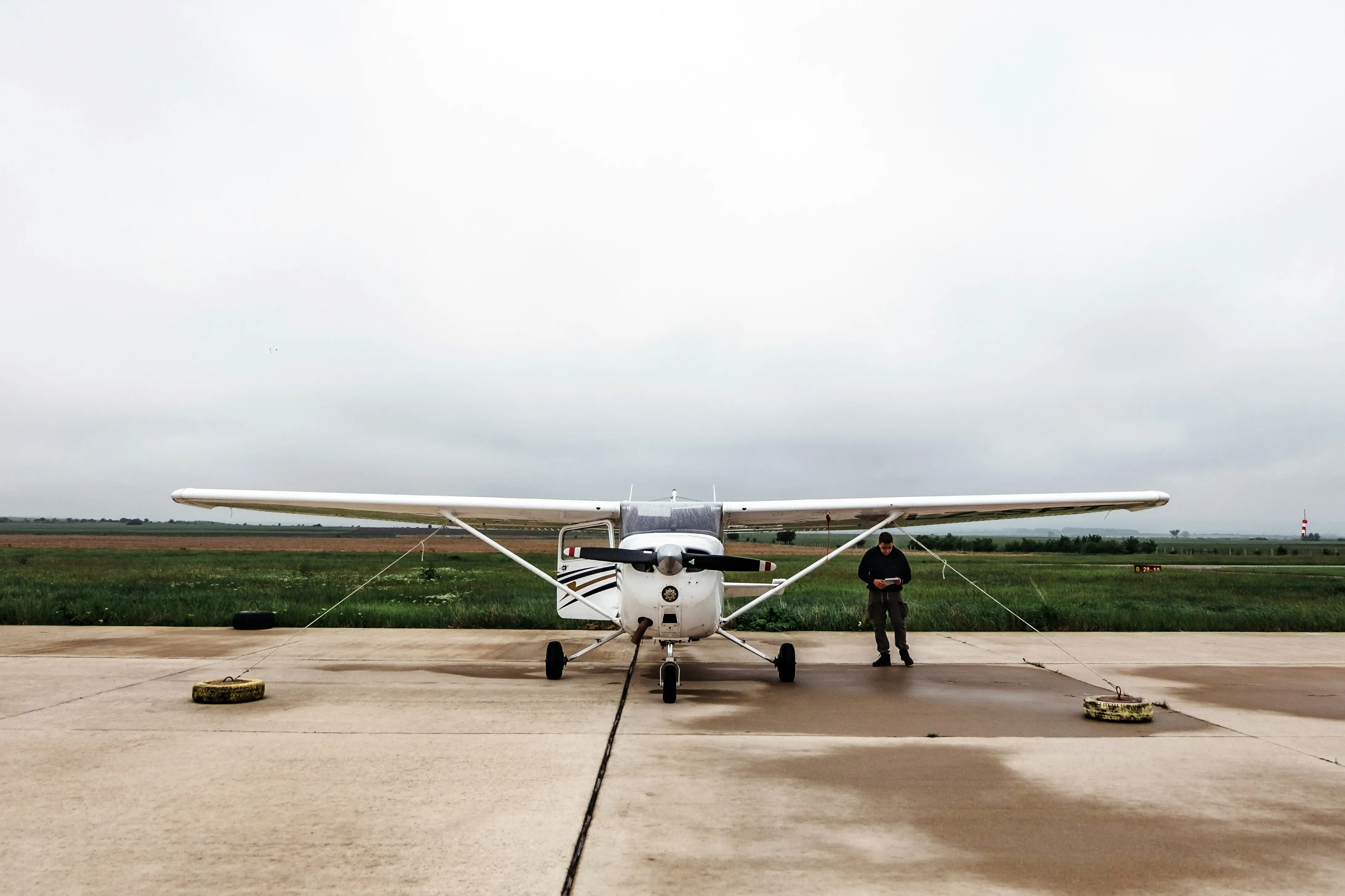 Pilot standing near airplane by Maria Teneva