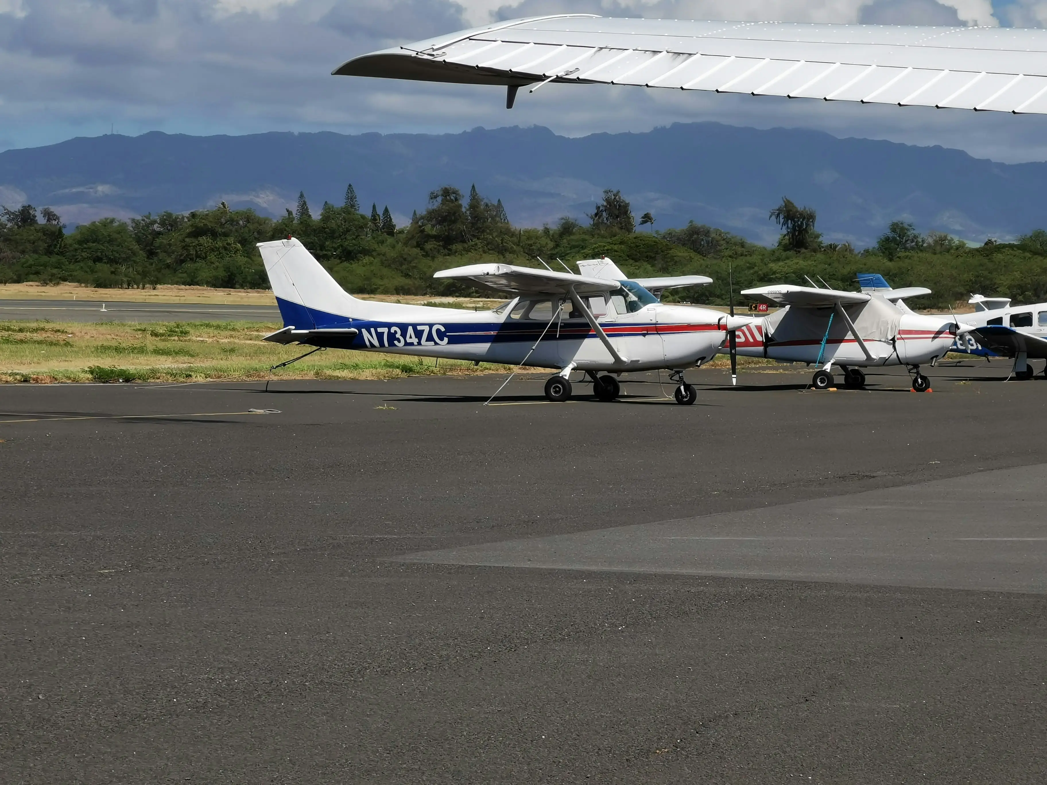 Multiple airplanes on ground by Aidan Tottori