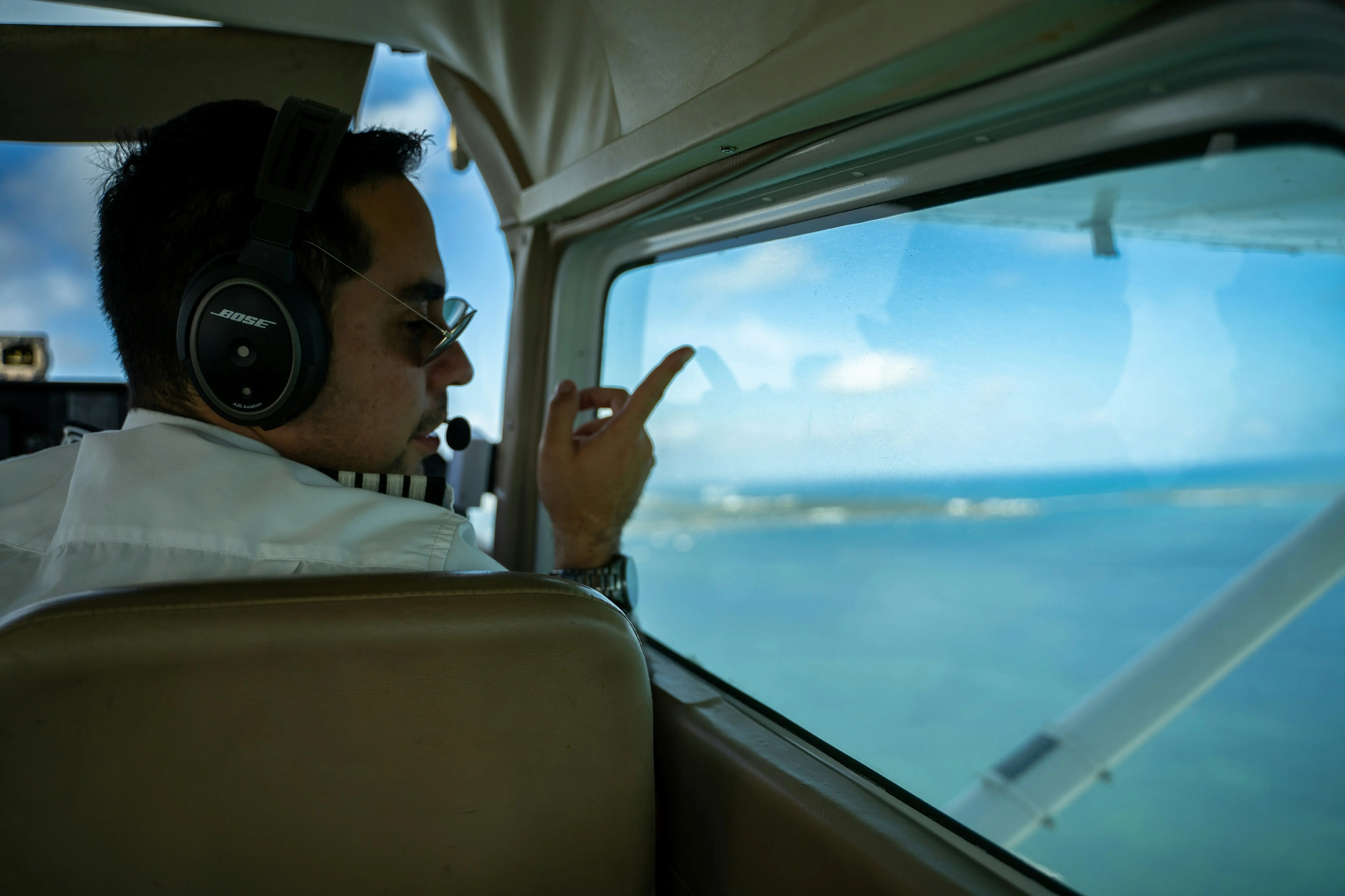 Pilot looking out aircraft window by Pasqualino Capobianco