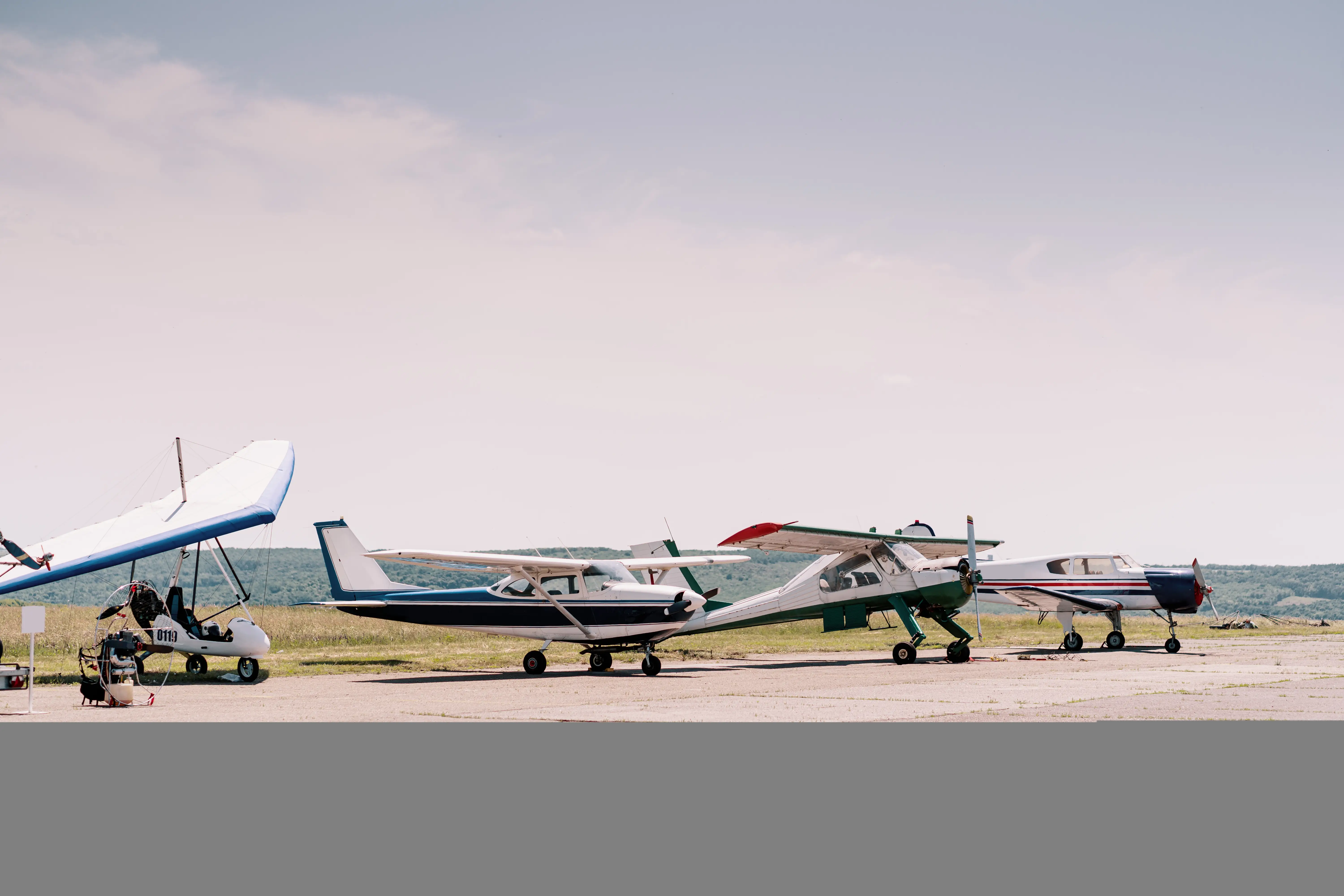 Private airplanes parked on field